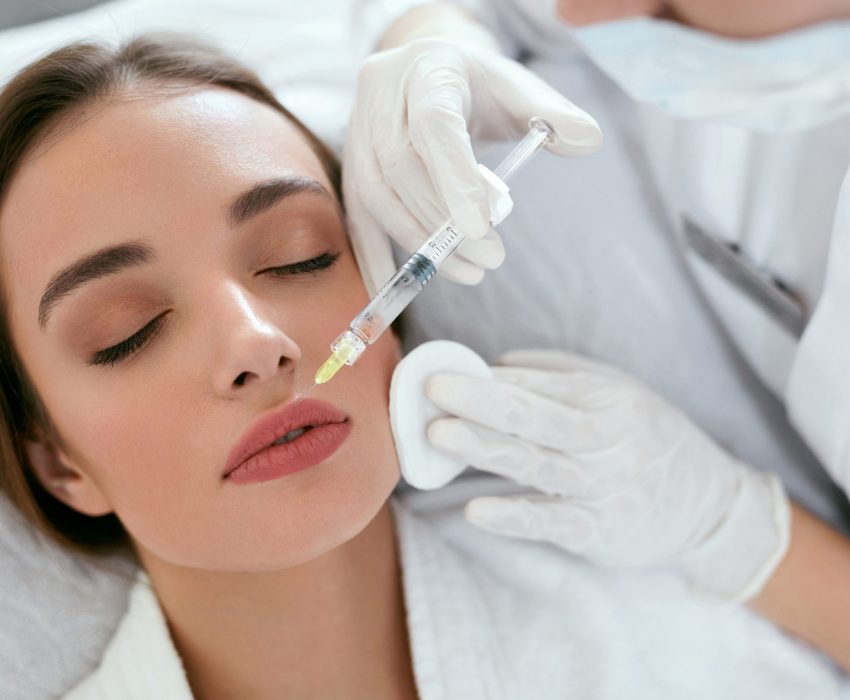 lip augmentation. woman getting beauty injection for lips